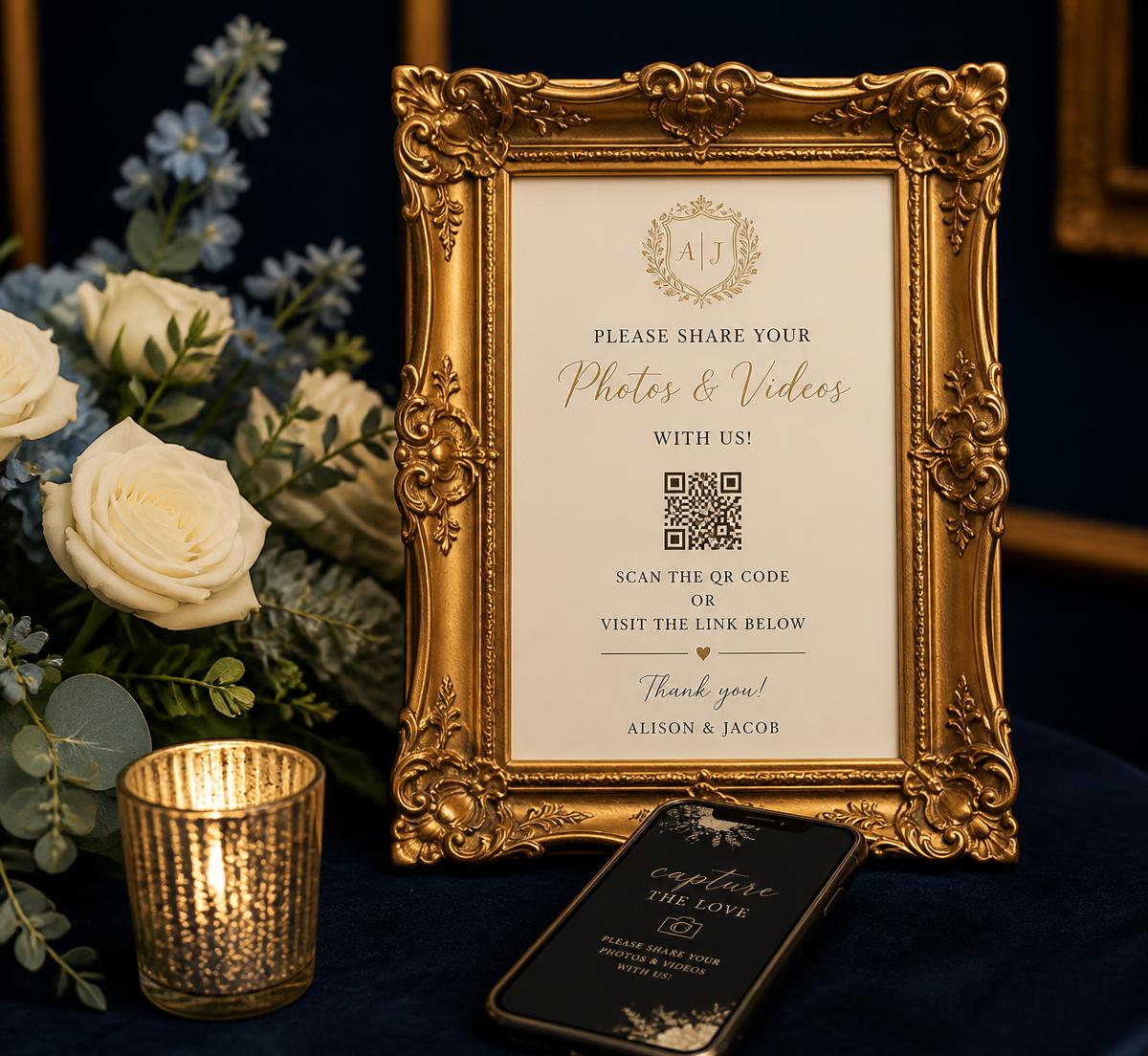 Framed wedding QR sign beside a smartphone, ivory roses and a candle